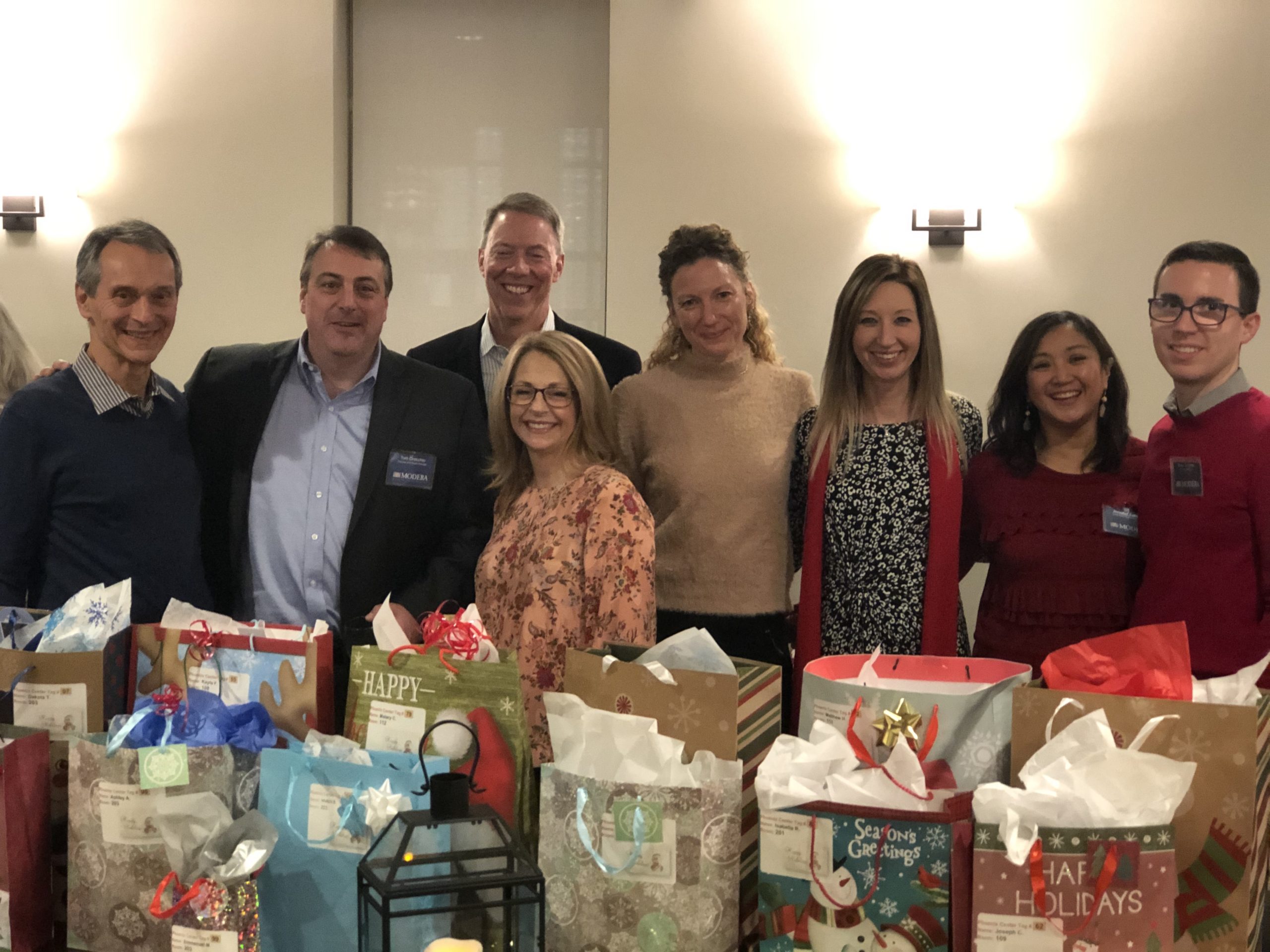 the Modera NJ office wraps gifts to benefit kids of the Phoenix Center